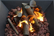 Load image into Gallery viewer, Gas fireplace faux logs and pinecones burning with bright orange flames inside a black firebox.
